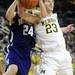 Michigan sophomore Evan Smotrycz gets tied up with Northwestern senior John Shurna in the second half against Northwestern at Crisler Center on Wedensday. Melanie Maxwell I AnnArbor.com
